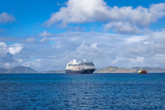 Cruise ship with mountains in background.