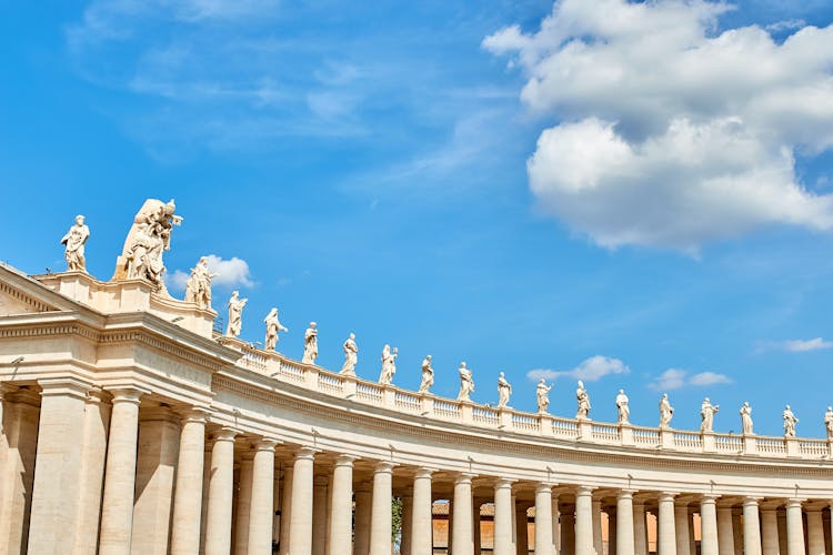 Ancient colonnade with sculptures on top