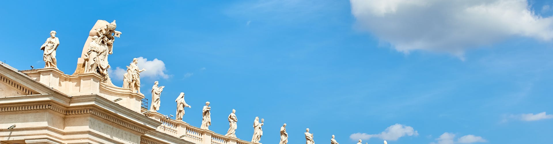 Ancient colonnade with sculptures on top