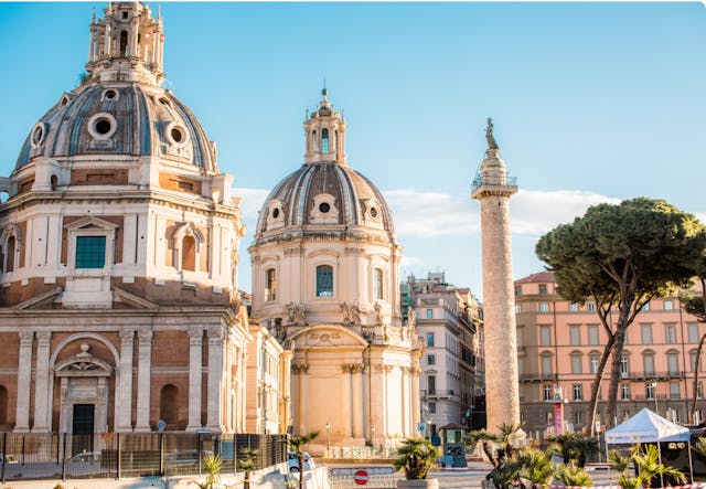 Old roman domed buildings next to column in city square