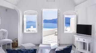 Hotel sitting room looking out door at sea