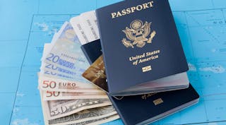 United states passport and cash on top of map