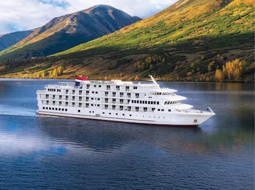 Riverboat on river with mountains in background