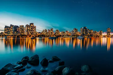 City skyline at dusk with bay in foreground