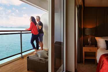 couple in balcony stateroom on cunard ship