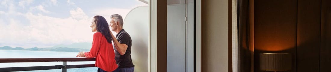 couple in balcony stateroom on cunard ship