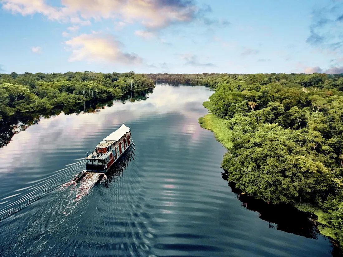 ship sailing in amazon - aqua expeditions