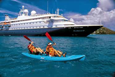 couple kayaking near seadream ship