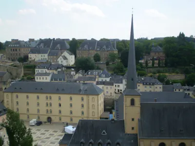 View over historic European town with slate roofs, church spire, courtyard and hillside houses