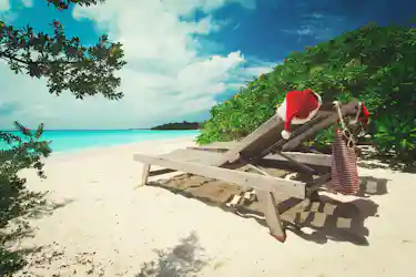 santa hats on chairs on the beach