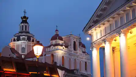 Evening view of Baroque church domes and illuminated neoclassical columns