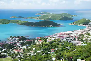 Panoramic aerial view of turquoise bays, green islands, marinas, sailboats, and coastal town