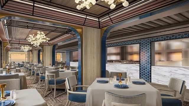 Fine dining room with white tablecloths, blue chairs, chandeliers, marble service counter