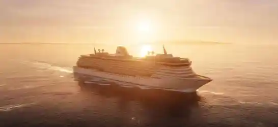 Large white cruise ship named Crystal sailing at sunset across calm open sea