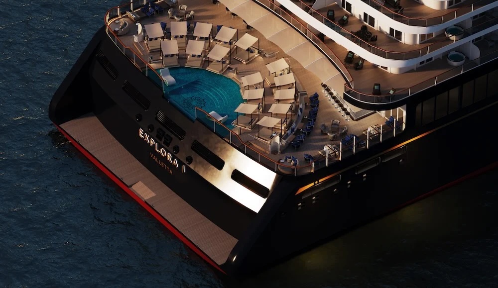 Aft deck of luxury ship EXPLORA I with circular pool, sun loungers and tiered decks at sea.