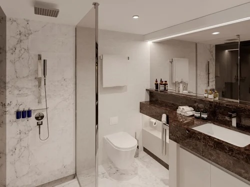 Modern marble bathroom with glass shower, wall-mounted toilet, dark stone vanity and sink