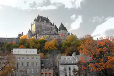 Historic château-style hotel landmark with steep turrets atop a hill, autumn trees and stone town below