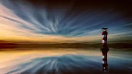 Lone red-and-white lighthouse reflected in calm water under streaked blue and gold sunset sky