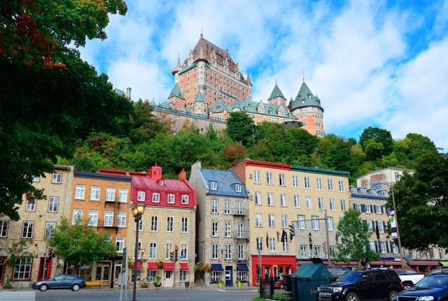 Old fashioned storefront with forest and castle in background